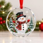Christmas crystal glass ornament featuring a traditional snowman surrounded by snowy Christmas trees